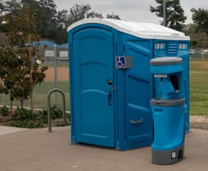 ada compliant porta potty next to a baseball field